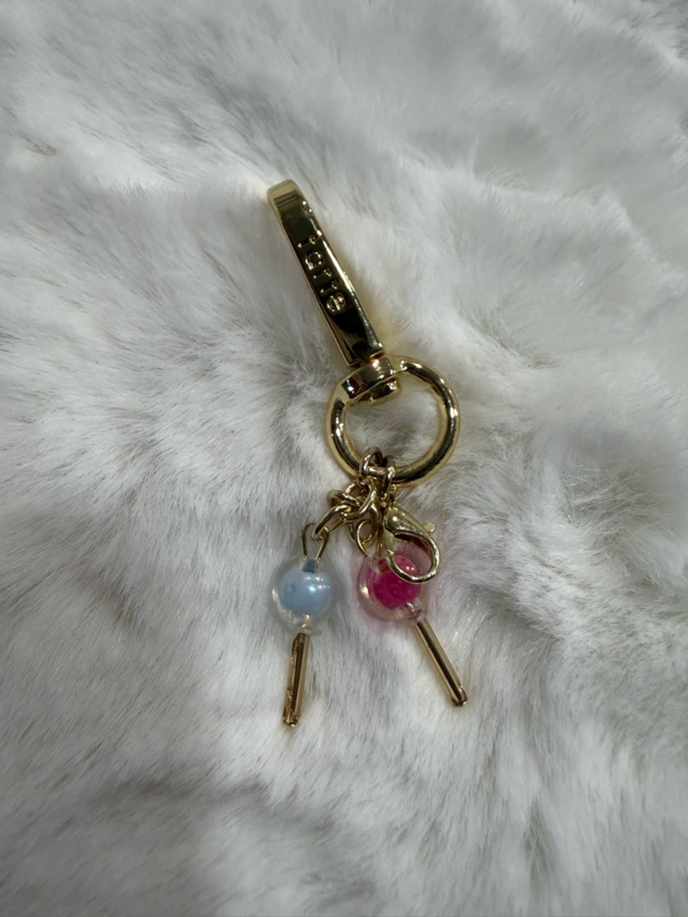 Tarte Cosmetic Collectable Gold
Keychain with Baby Blue & Pink Rattles